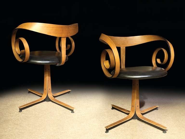 # Y036 - PAIR George Mulhauser designed chairs for Plycraft.
Note the artistic use of bent wood for the back which evolves seamlessly and beautifully into the spiral arm termination. The column base also with applied bent wood which splays into 4