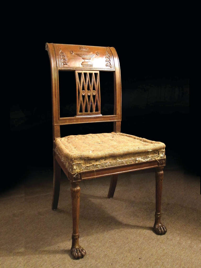 # W084 - Directoire beechwood side chair with wide curved crest rails centering carved urns above pierced lattice backs. The upholstered over seat, all raised on round tapering legs ending hairy paw feet.
The neoclassical form embodies the simple