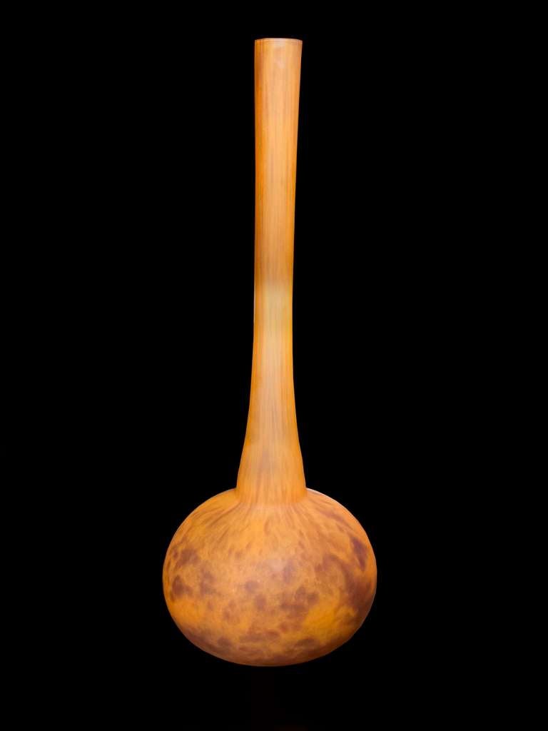 Wonderful and large-scale “Daum Nancy” art glass vase. The bottom is impressed with “Daum Nancy” and The Cross of Lorraine. This vase has soft orange color mottled with an abstract harmonizing burgundy color. The elongated neck tapers in and then
