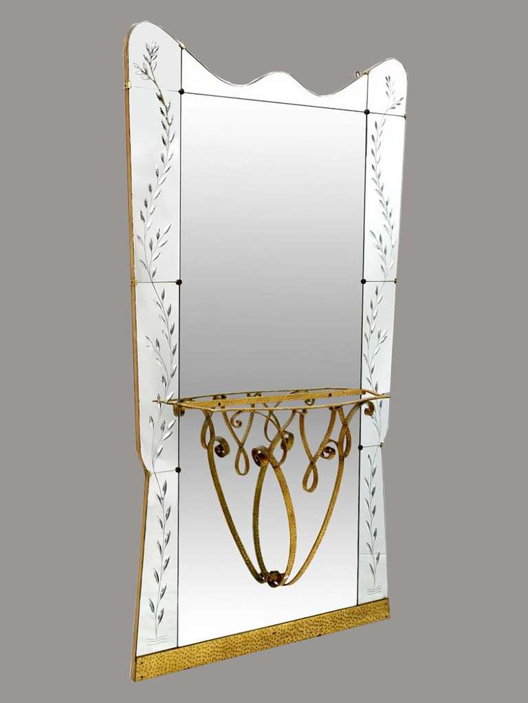# ZA609 - Fine Italian Mid-Century Modern gilded iron console table with mirror back after designs by Pier Luigi Colli (Italian, 1895-1968). The decorative shaped Fontana Arte style mirror engraved with a graceful foliate vine border design. The