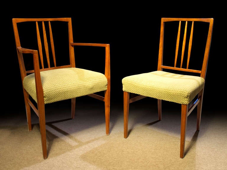 # T511 - English mahogany set dining 9 (2 teak arms and 7 mahogany sides) chairs made by Gordon Russell for the Festival of Britain, c 1951. The chairs designed by W.H. Russell with open panel backs and three vertical waisted splats, upholstered