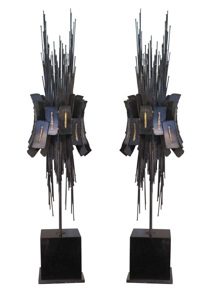 Pair of Brutalist metal sculptures patinated bronze and brass. The bunched rods belted and all raised on a black marble base. American, circa 1970 (# ZA614).
Click on 