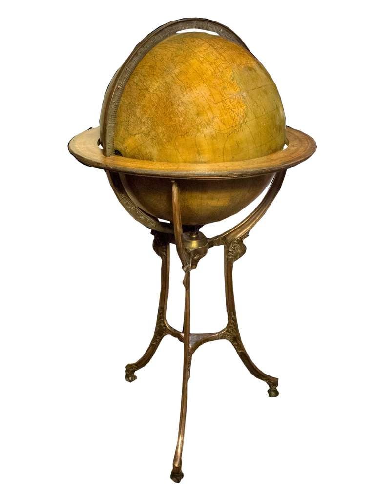# Y076 - Hammond 18” terrestrial floor globe having wood equatorial ring, set in an Art Nouveau metal tripod stand with casters. Commencing in the late 19th century, Hammond & Co., located in New York, Brooklyn and Boston, was a prominent maker of