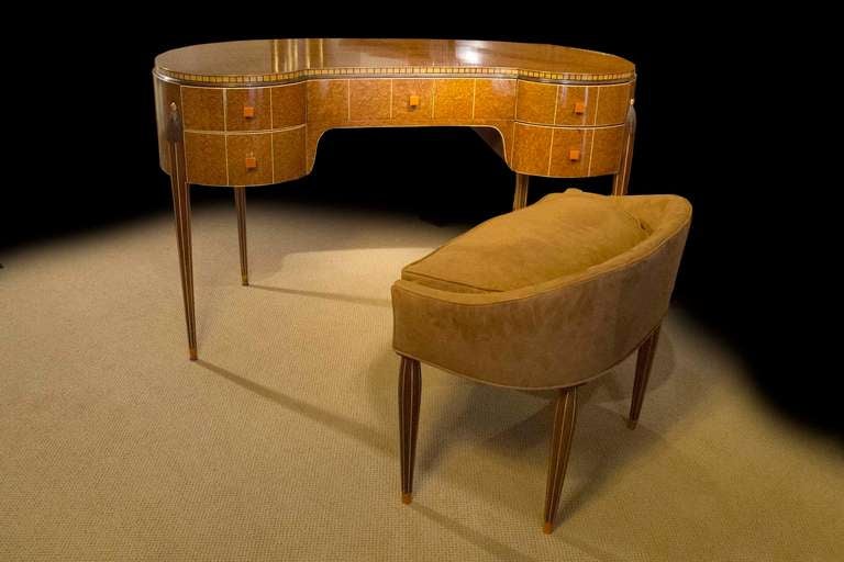 # Y061 - Art Deco kidney shaped Amboyna wood desk  in the manner of Emile-Jacques Ruhlmann.  The top is finely veneered with  Amboyna wood surrounded by a checkered border. The front has five drawers nicely trimmed with white inlay and mounted with