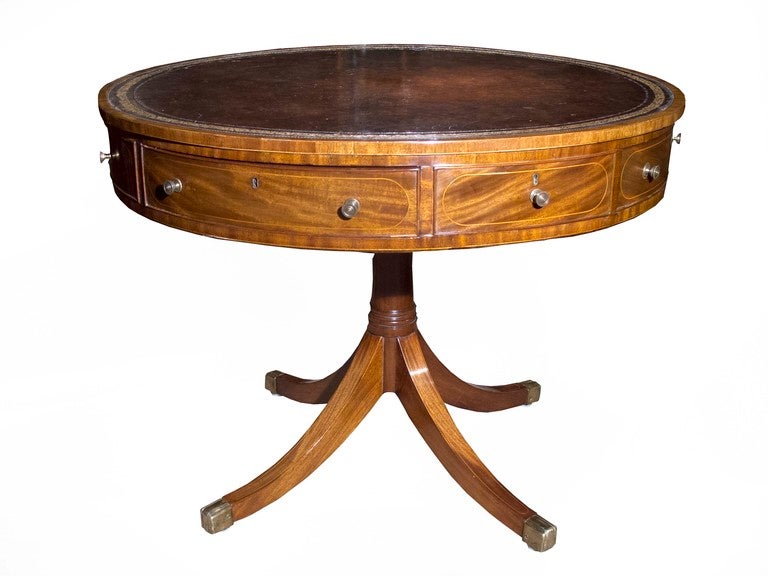 # X025 - Handsome George III mahogany drum table with a nicely faded old leather top enriched with gold tooling. Note the subtle use of satinwood crossbanding around the top and boxwood string inlay around the drawer fronts which serves to emphasize