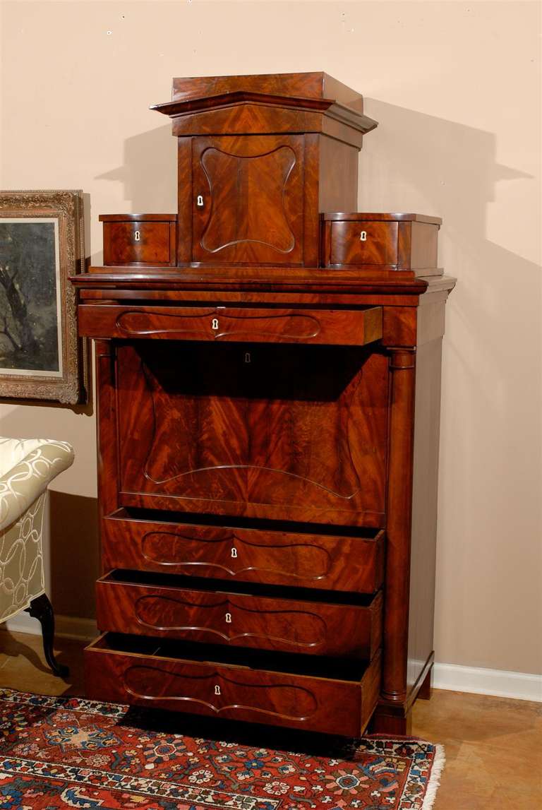 Rare and outstanding Biedermeier secretary in superior condition. A flame mahogany that is matched from top to bottom. Drawers have original ivory button knobs with satin wood stringing detail. This beautiful secretary has every detail one expects