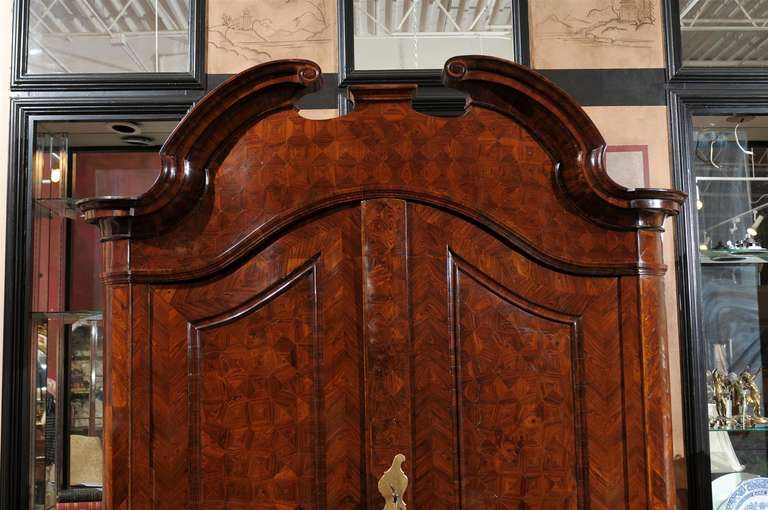 This fabulous shrank is all original with bronze handles and pulls which have been cleaned and brightened to its original patina. Notice the spectacular detail of the parquet pattern inlay on the entire cabinet. The cabinet breaks down into three