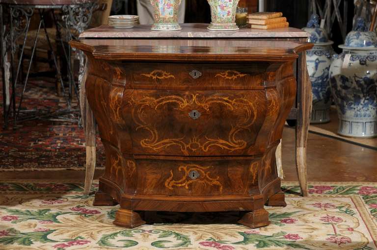 This exquisite 19th c. walnut and rosewood chest with a serpentine top has 3 drawers with bronze hardware. There is satinwood scroll inlay on the drawers and sides