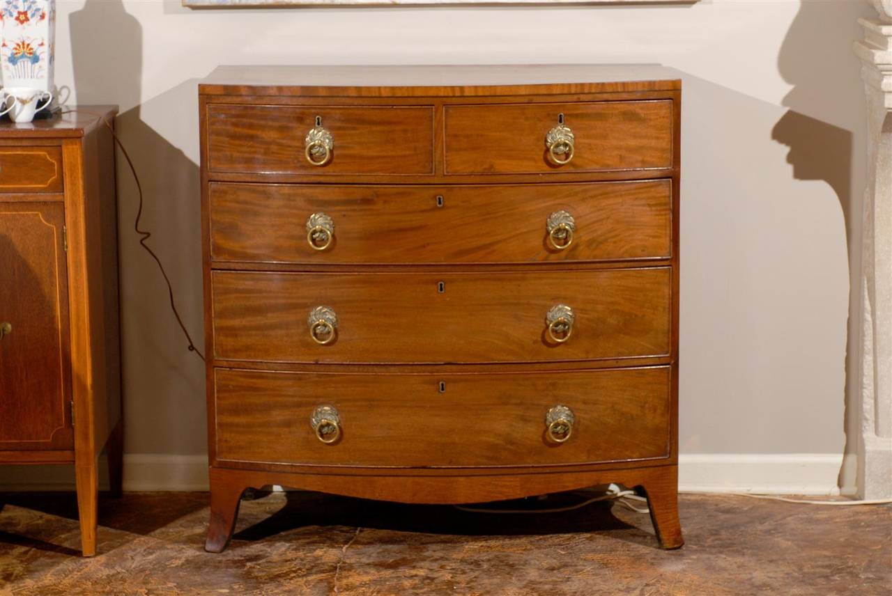 Early 19th century chest of drawers with inlay, integrated cross banded top, case with two short over three long drawers and shaped skirt with splay feet.