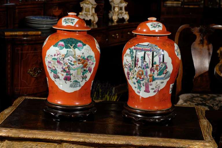 Two lovely large ginger jars with original lid and wooden base. The pattern is on both sides and is a scene of banquet preparation or celebration. They are sold individually. Excellent condition. If you need a large lamp they would be beautiful made