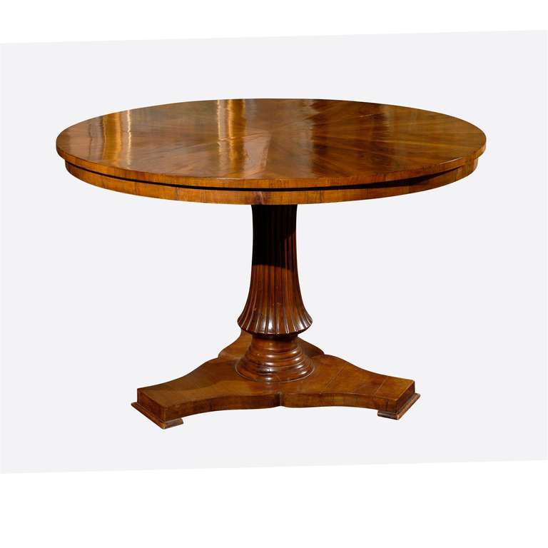 This is a gorgeous walnut center table or could be used for dining. The beautiful grain on the top forms a starburst type pattern and has a fluted pedestal base.