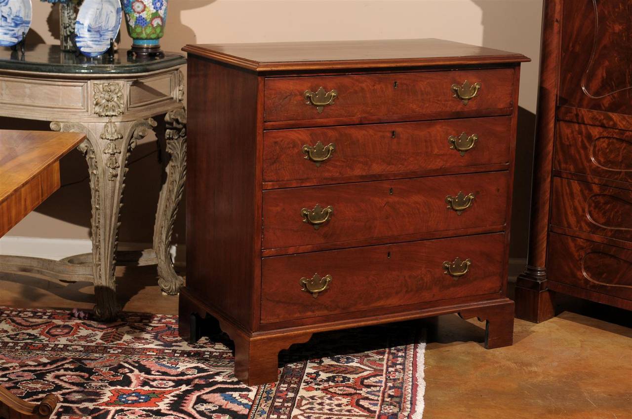 This handsome early 19th century chest has a rectangular molded top over case with four long graduated drawers on bracket base. Perfect piece for any room.