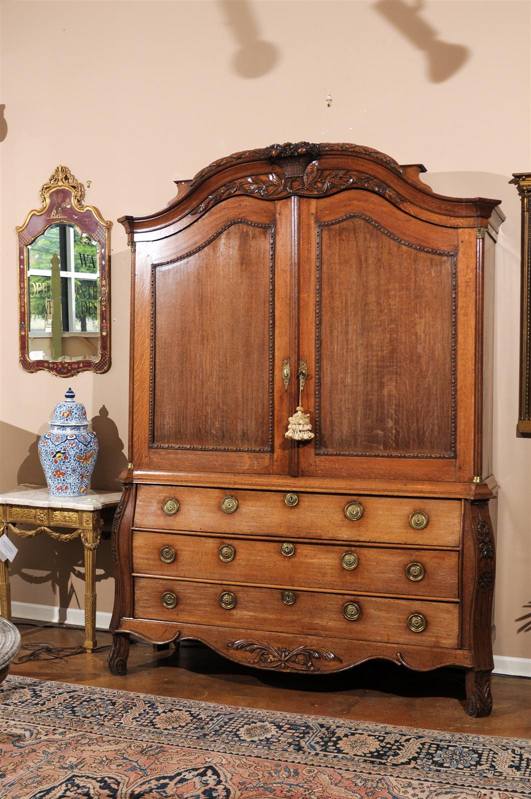 This is a magnificent 18th century "Dutch Kabinet" the Dutch were known in this period to craft in the bombe style. This piece was used to store a mixture of china and linens. There is a large cupboard that and a set of three large bottom