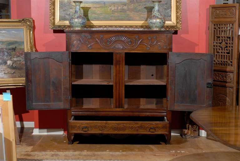 Beautiful French carved walnut cabinet with large drawer on the bottom and two hinged doors.