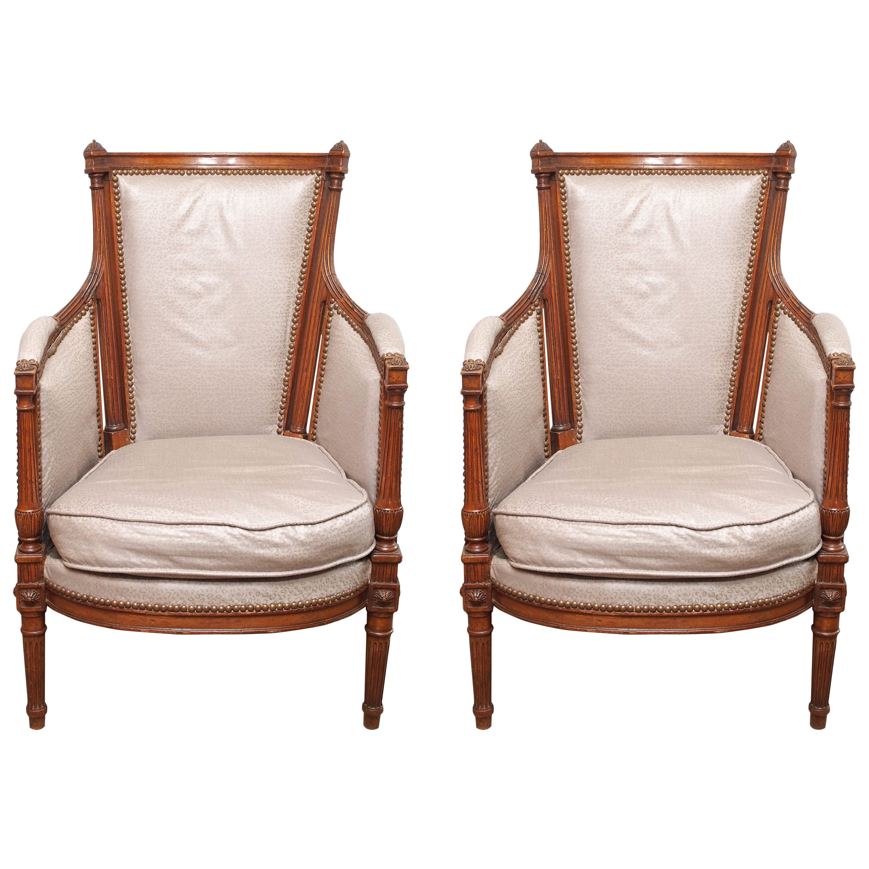 Pair antique French walnut Louis XVI upholstered bergeres