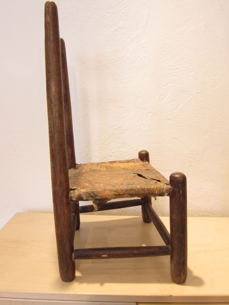 This is a very early and rare child's ladder back chair from the South, possibly North Carolina or Virginia.  Walnut slats grace the entire back, and cross stretchers secure the legs.  The chair retains the original surface, as well as the original