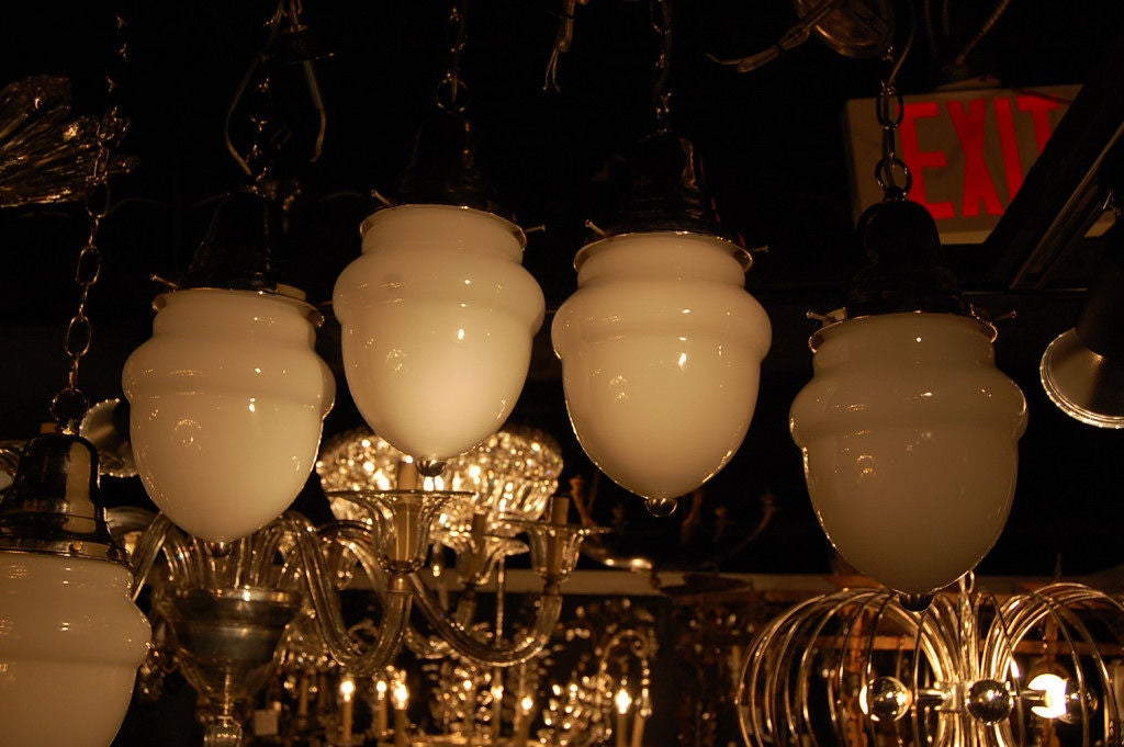 Large set of opaline glass light fixtures with nickel plated hardware. Priced per fixture