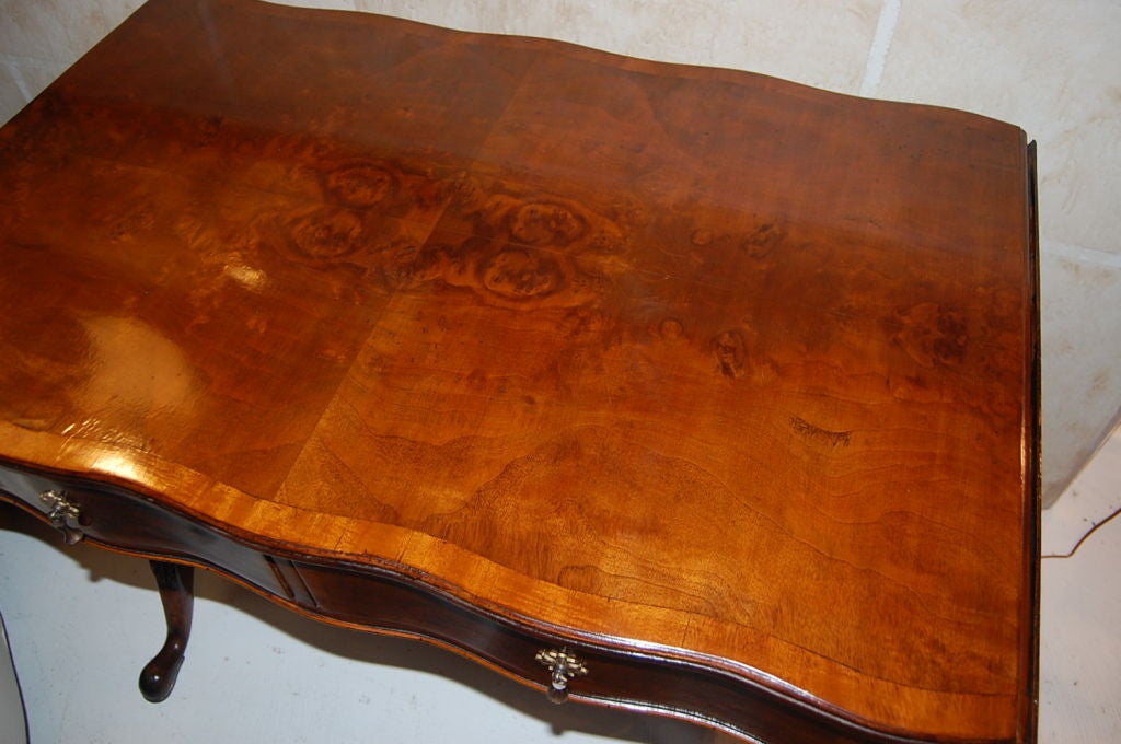 Nicely figured mahogany drop leaf library table with two drawers.