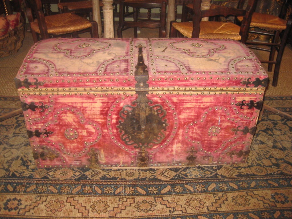 Red velvet Spanish trunk with decorative nail head patterns