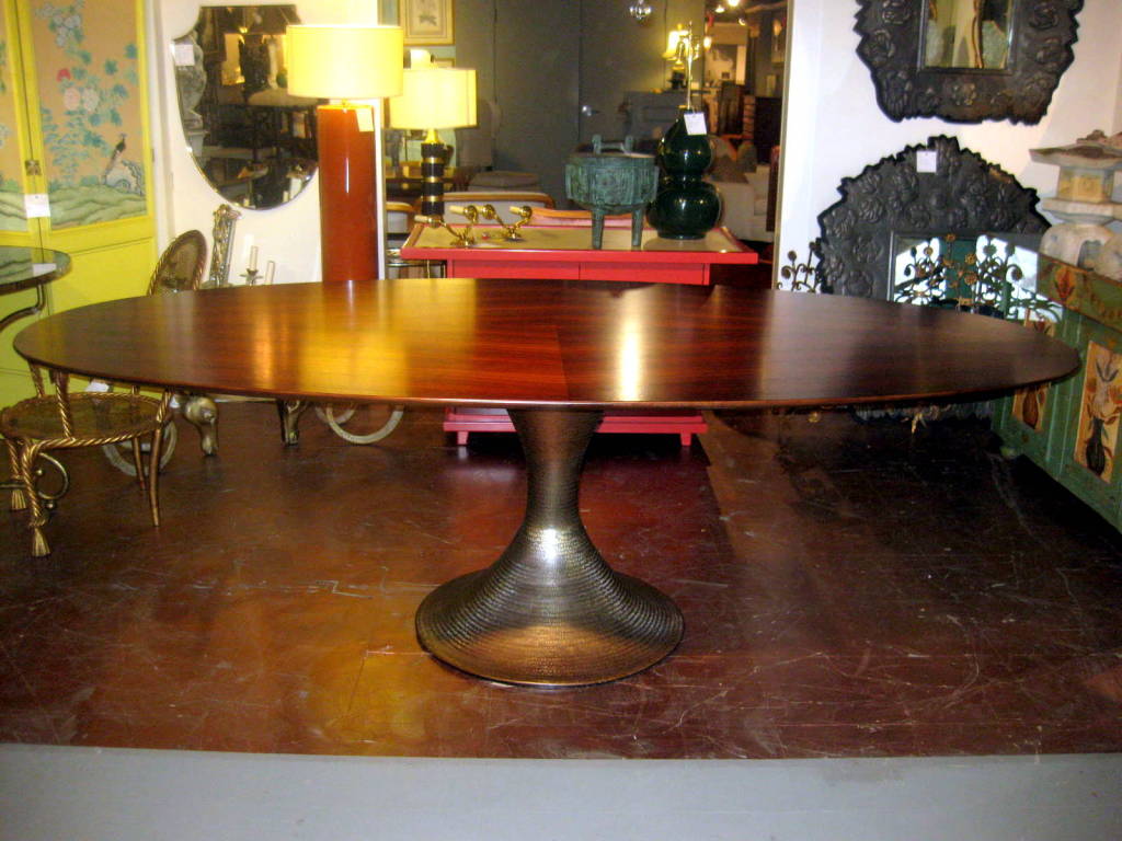 Fabulous oval dining table. Rosewood top and a hammered metal base