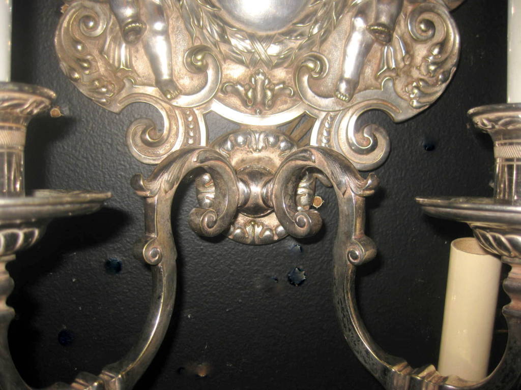Pair of silverplated E.F. Caldwell sconces with the original finish.