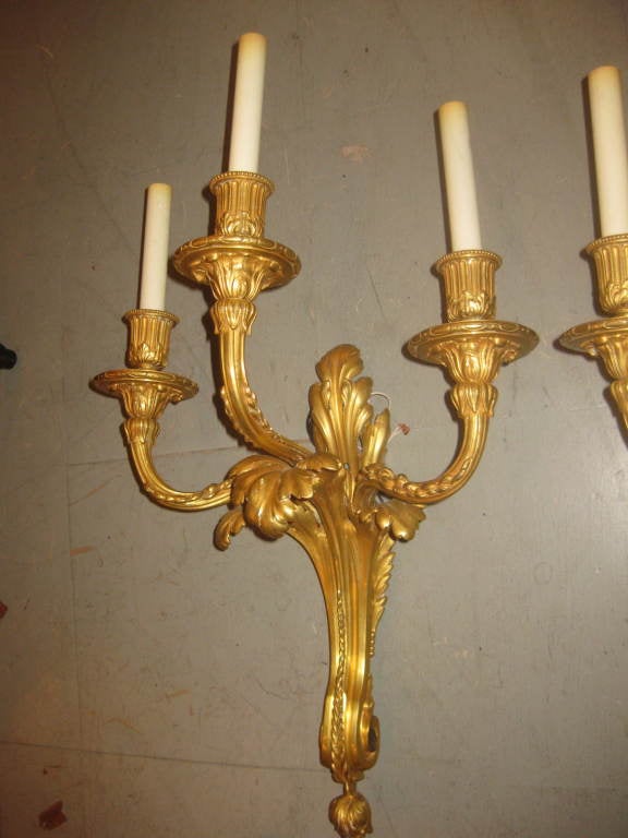Pair of E. F. Caldwell museum quality gilt bronze sconces. Weighty with great patina from an age of superior quality casting.
