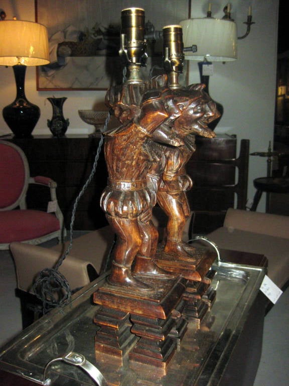 A pair of carved figures made into lamps