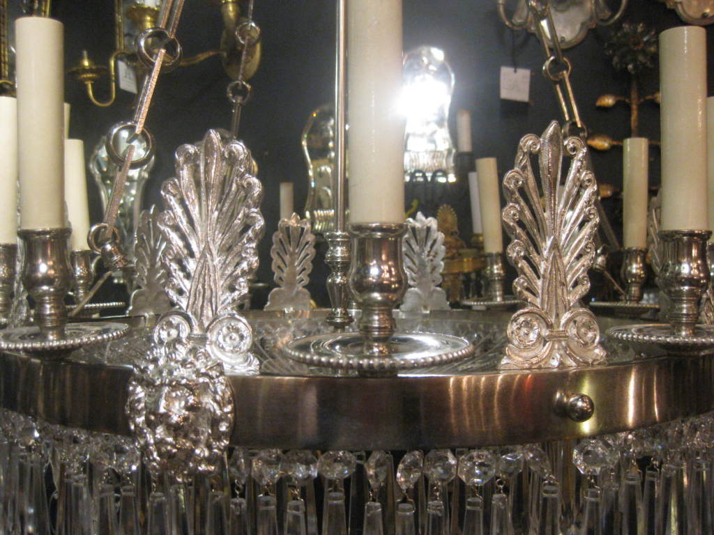 A C.1900 French Empire style silverplate chandelier with cut crystal inset and lions heads