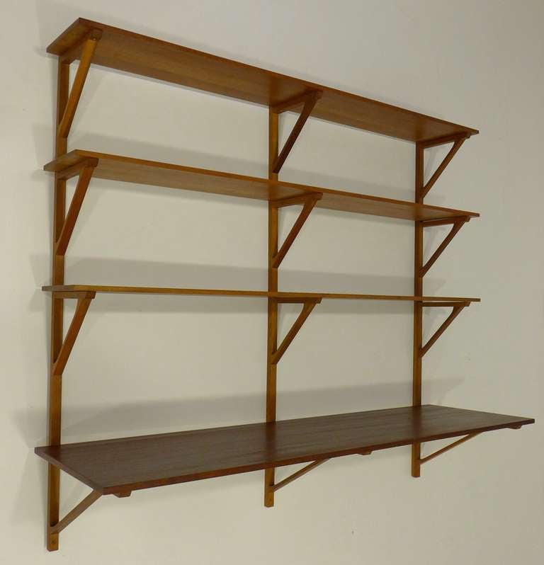 Hanging bookshelves and desk by Borge Mogensen made for Illums Bolighus, circa 1960s. Solid oak shelves and risers offset by solid teak desk component. An elegant and seldom-seen Danish design. In fine original condition with only minor evidence of