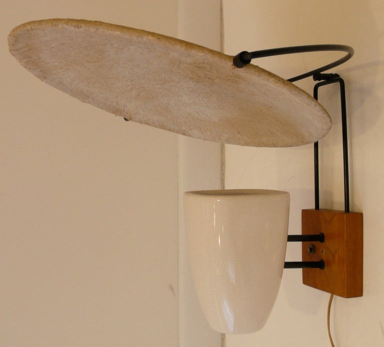 Wall sconce of fiberglass, ceramic, walnut, and iron by
California designer Mitchell Bobrick, produced c. 1949.  Featured in 