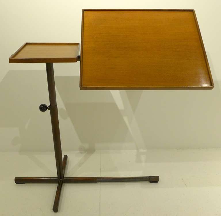 Constructivist-looking, adjustable, multi-function table with walnut trays and bakelite knobs designed by Francois Caruelle and made by the Swiss company Embru, c. 1950. The copper-plated, tubular steel base adjusts from about 26