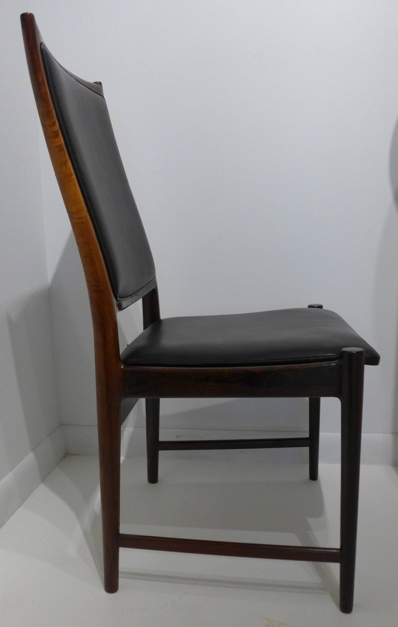 Well-crafted chair with high back and graceful and fluid lines, of solid and nicely figured Brazilian rosewood with leather seat and back, by leading Norwegian furniture designer Torbjørn Afdal. Made at the Bruksbo furniture workshop for