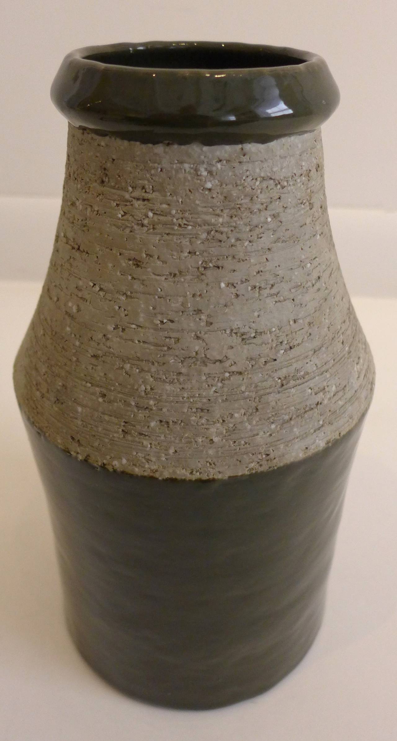 Vase with contrasting glazed and chamotte surfaces, the glazed area being dark green. By Swedish studio potter Hertha Bengtson, made at Rörstrand, circa 1960s. With painted marks on bottom.