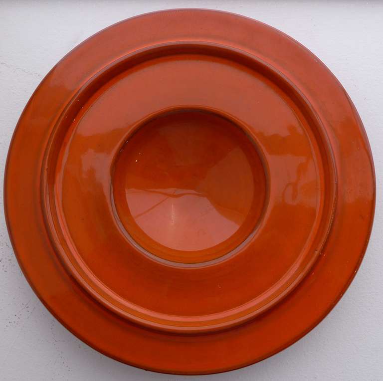 Dish or ashtray, model #492 designed by Ettore Sottsass and produced by Bitossi for Galerie Il Sestante, c. 1962. Hand-thrown and glazed in an uncommon orange/red color.  In mint original condition, with full markings.  Illustrated, in white, in