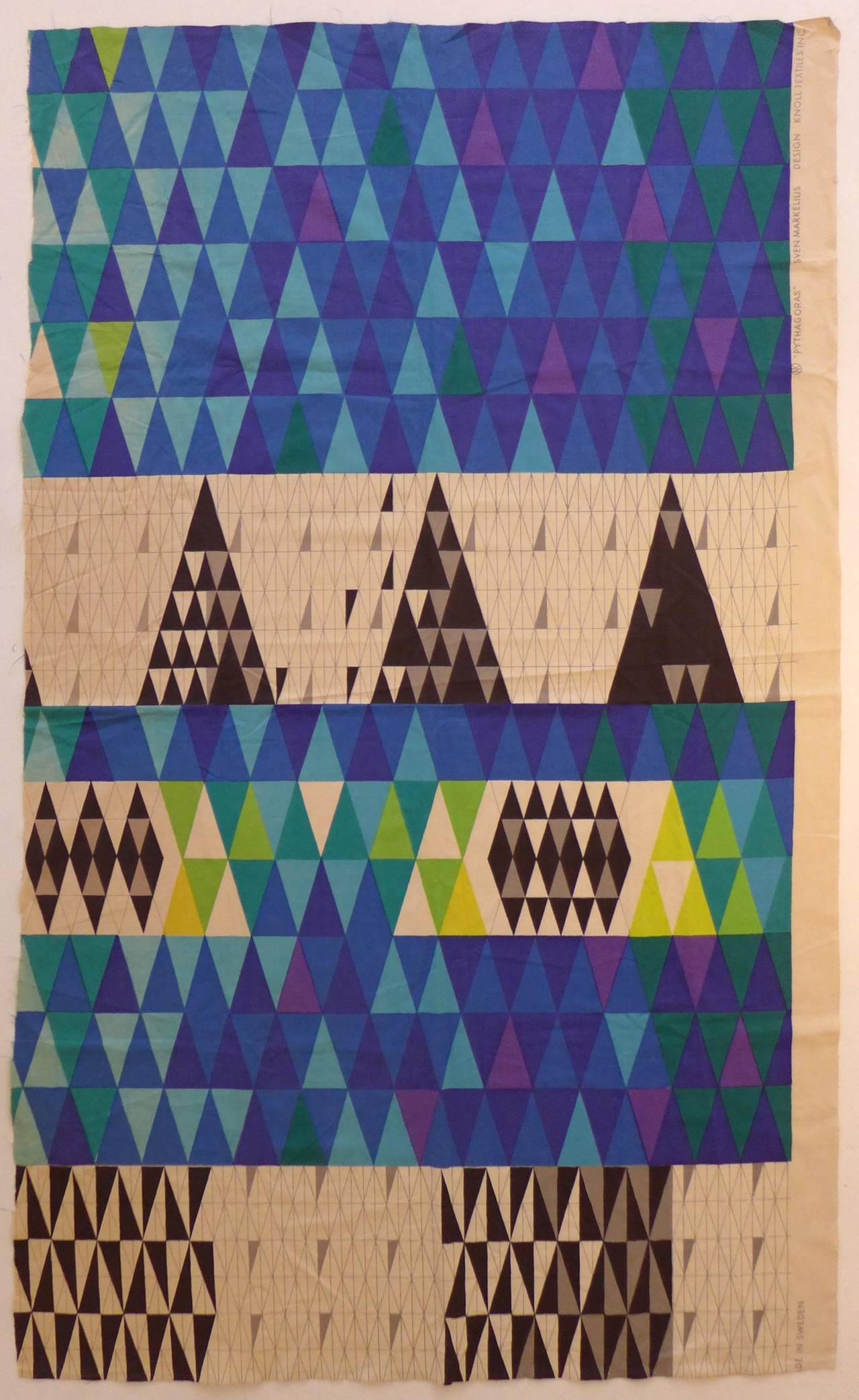 Large swatch of screen-printed fabric with a complex geometric pattern, titled 