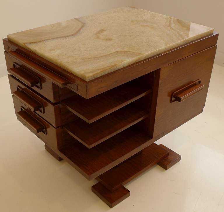 Pivoting side table or cabinet of highly figured mahogany with a marble top and Japanese maple interiors.  Features a pull-out tray, shelves, plus drawers and and cabinets for storage.  The box swivels on metal plates. An Art Deco design made in