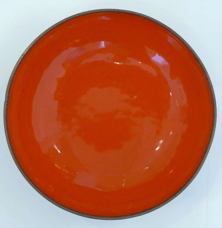 Small enamel on copper dish with vivid red/orange interior by Austrian/American designer Ernst Lichtblau (1883-1963).  Trained as an architect and engineer in Vienna and in master classes with Otto Wagner, Lichtblau worked as a freelance architect