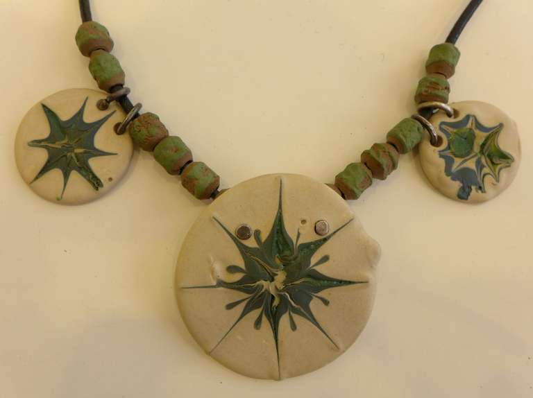 Necklace composed of ceramic beads and medallions, with silver clasp and inserts, executed circa 1960. Designed by Edith Heath (1911-2005), a studio potter who founded Heath Ceramics in 1948. From the estate of Edith Heath. Signed. The largest