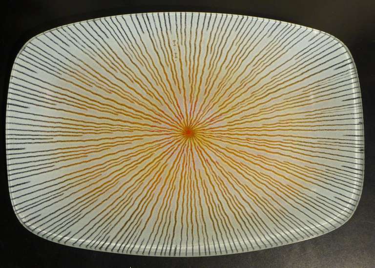 Large dish of sand-cast glass with an abstract radiating pattern by Swiss-born American designer and artisan Maurice Heaton (1900-1990).  A descendent of generations of stained glass makers, Heaton gained recognition for his colorful and textured