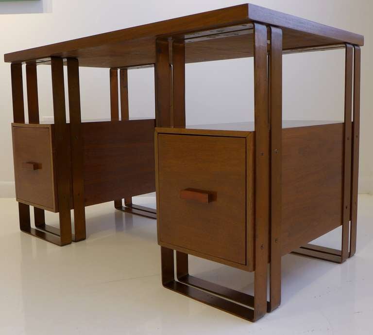 Rare desk in walnut and banded copper-plated aluminum, designed by Donald Deskey and produced by Ypsilanti Reed Furniture Company, circa 1929. A strong statement of Machine Age aesthetics, rare to the market. Ref: David Hanks, 