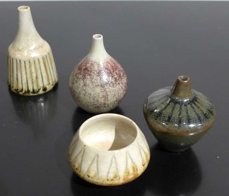Four miniature stoneware vessels by Swedish ceramist John Andersson, produced at  A & J Hoganas Keramik, c. 1960's.  Includes a footed bowl and three small vases with tapering spouts.  Tallest piece measures 1.25