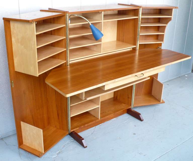 Fold-out work station in teak and birch with a pull-out desk, shelves, drawers, and the original gooseneck lamp.  Made by Pfeiffer in Norway, c. 1960's.  
The dimensions closed are H 45
