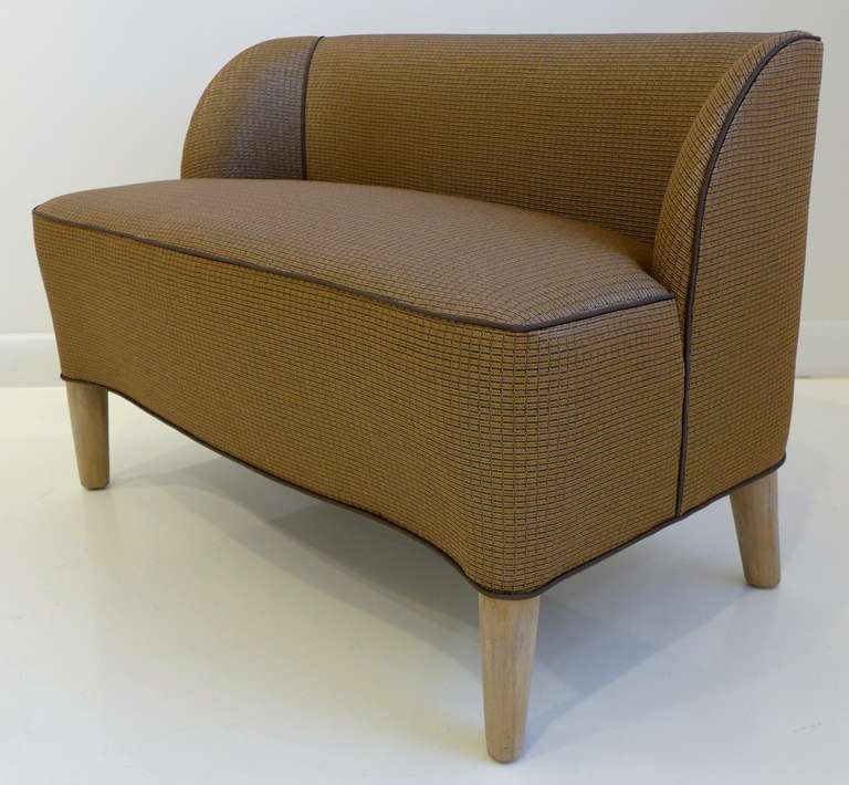 Diminutive and gently curvilinear slipper bench designed by Edward Wormley for Dunbar Furniture. This rarely seen design is shown as model #2425B in the 1938 Dunbar catalog. Newly reupholstered in a Pollack fabric following the details illustrated
