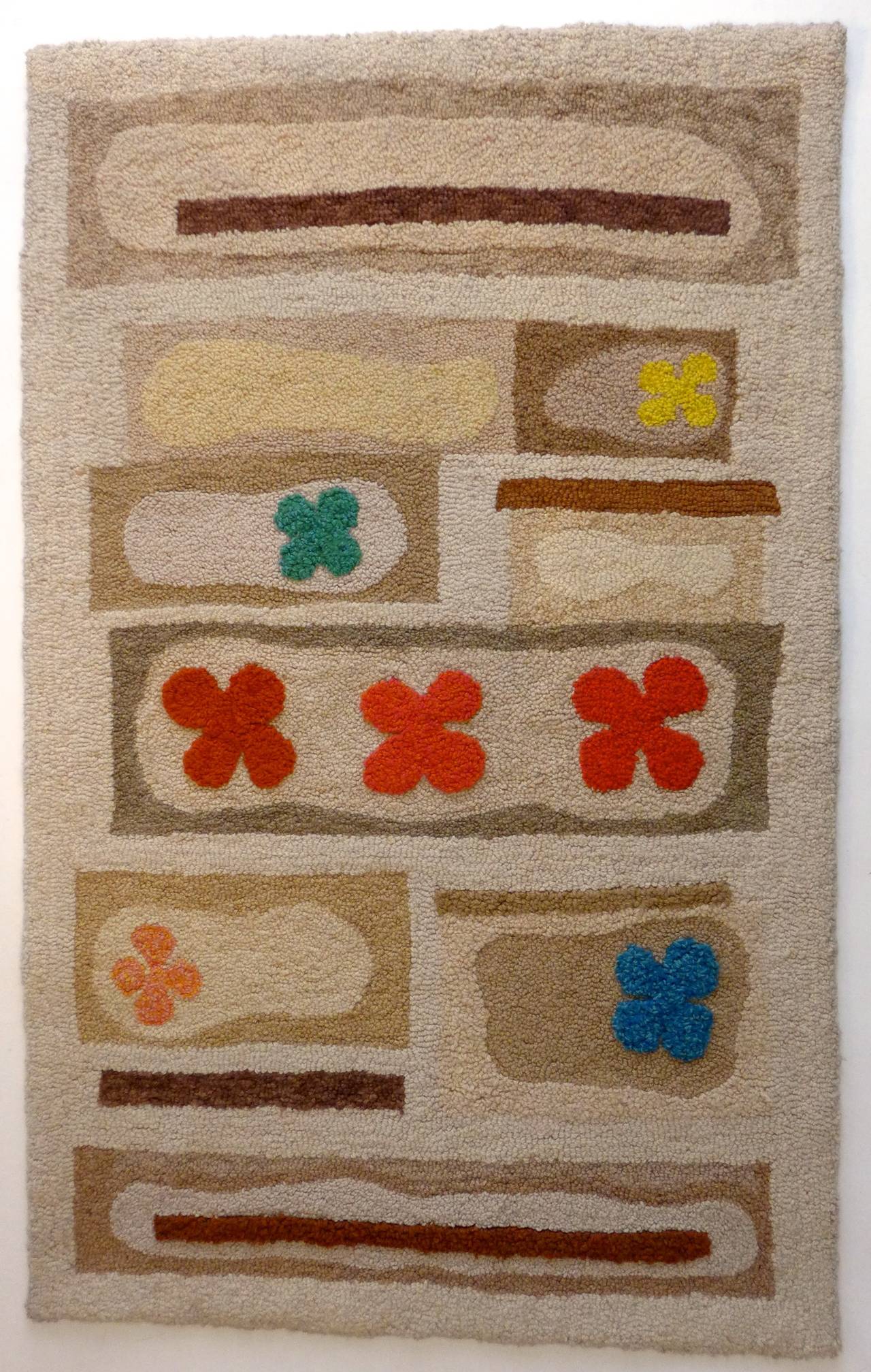 Hand-tufted wool rug with an abstract design featuring bright colors on a beige and cream background. Attributed to V'Soske, circa 1960. The original owner had it hanging vertically on the wall (see attached picture), fastened with a wooden batten,
