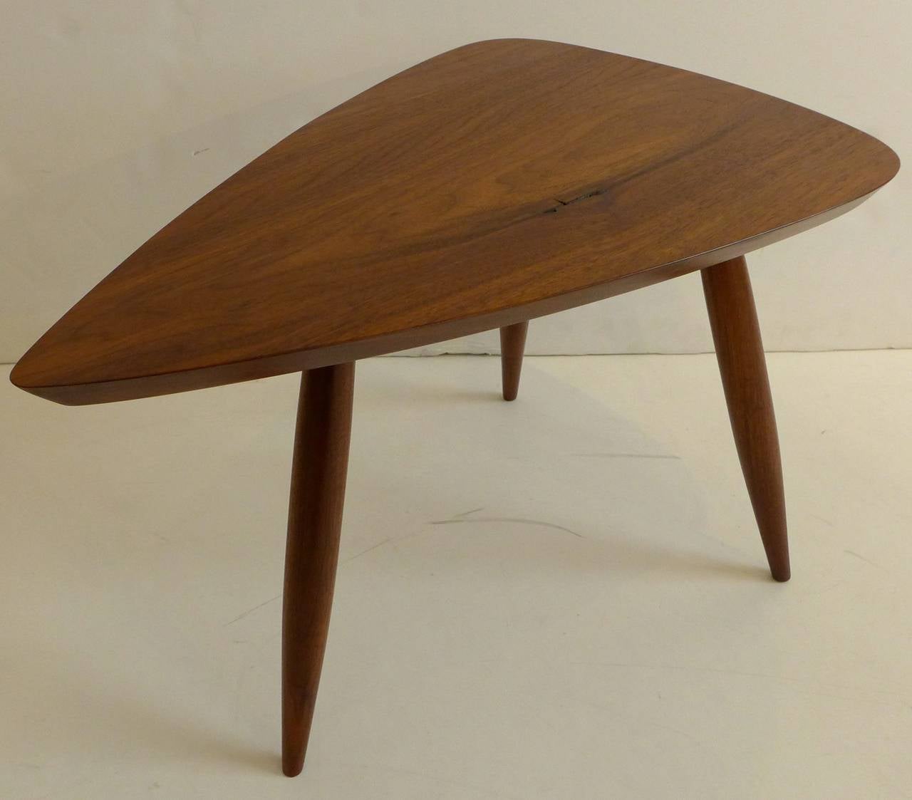Guitar-pick shaped occasional table of American black walnut by New Hope craftsman Phillip Lloyd Powell. Beautifully grained top with one small inclusion. In excellent vintage condition with hand-rubbed oil finish.