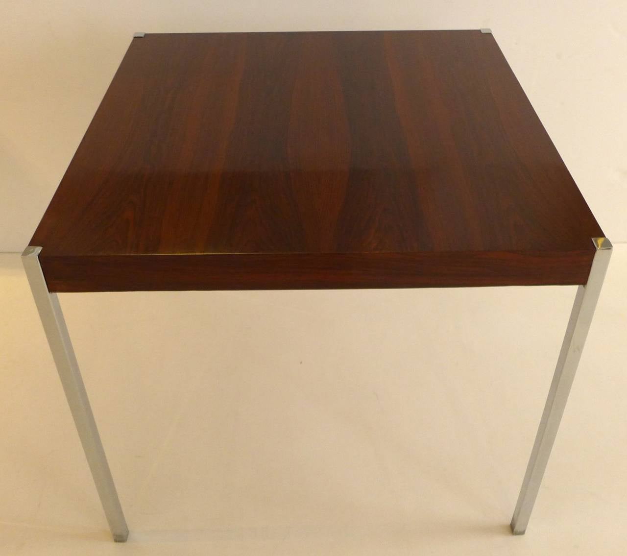 Square dining or dinette table in boldly figured rosewood with flush mirror chrome corner legs. Designed by Harvey Probber and made by Probber, circa 1960s. In beautiful refinished condition.