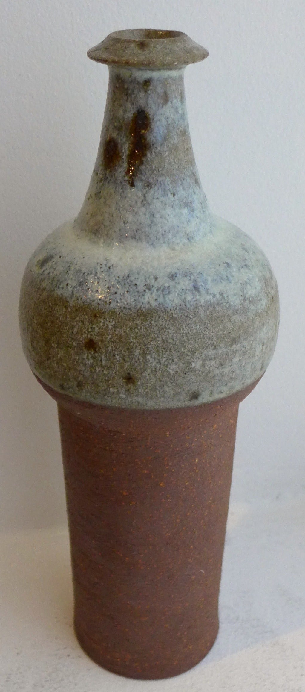Studio vase with bulbous center and flaring neck, circa 1960s. Multi-chromatic glaze on top, unglazed on bottom. By Danish painter, ceramist, and glass-maker Finn Lynggaard (1930-2011) Lynggaard studied painting and ceramics at the Royal College of