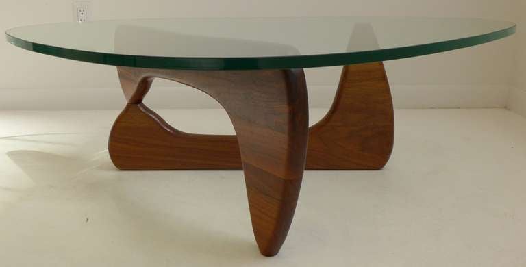 VIntage production of Noguchi's classic IN-50 table, in beautifully grained walnut with original tinted and polished glass top. Manufactured by Herman Miller in the 1970's.  Retains the original aluminum pin.