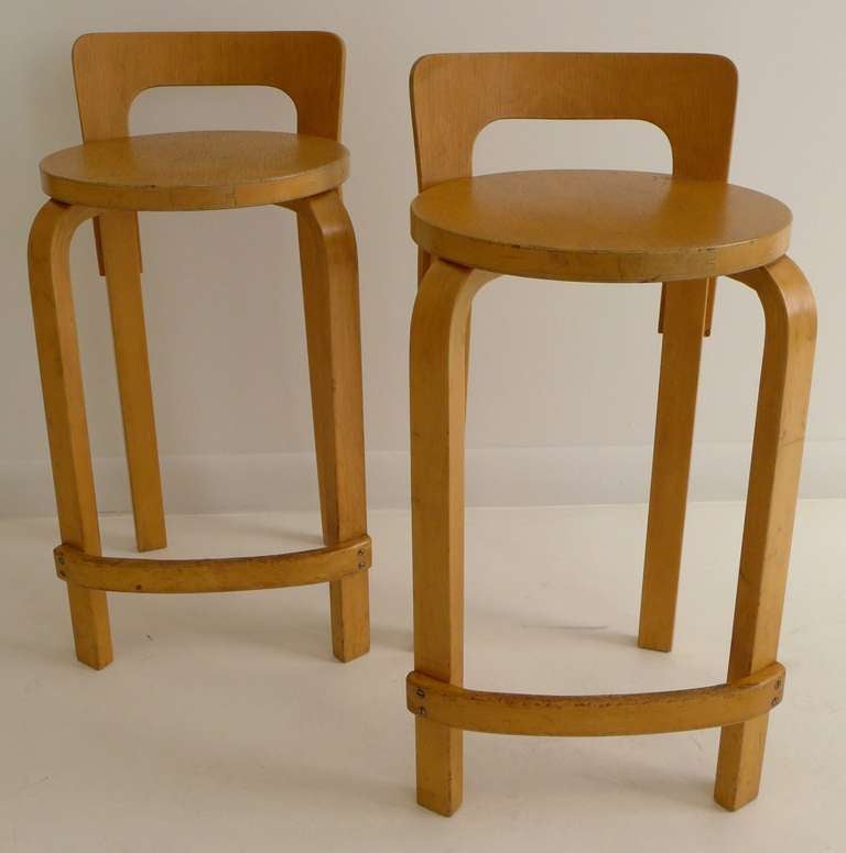 Pair of Aalto L-leg stools in birch and laminated birch, produced by Artek, c. 1950's.  Nice patina and character, though with surface wear throughout.  Price is for pair.