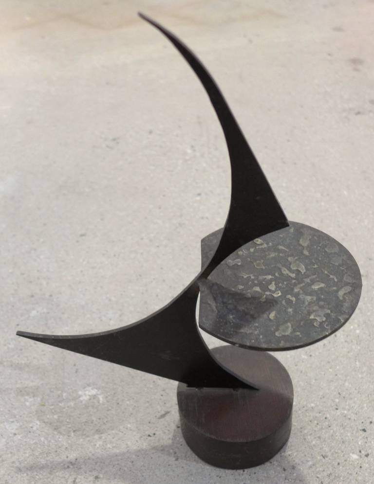 Cast and sheet bronze sculpture on wooden base by New England artist Homer Gunn (1919-2001).  Gunn studied at RISD from 1938-41, then at the Art Students League of New York.  He later taught at Deerfield Academy.  His public commissions include the